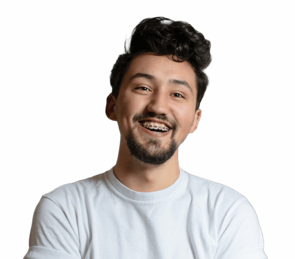 A young man with curly black hair and a beard, wearing a white shirt. He is smiling broadly and has braces on his teeth. The background is plain black, focusing attention on his cheerful expression.