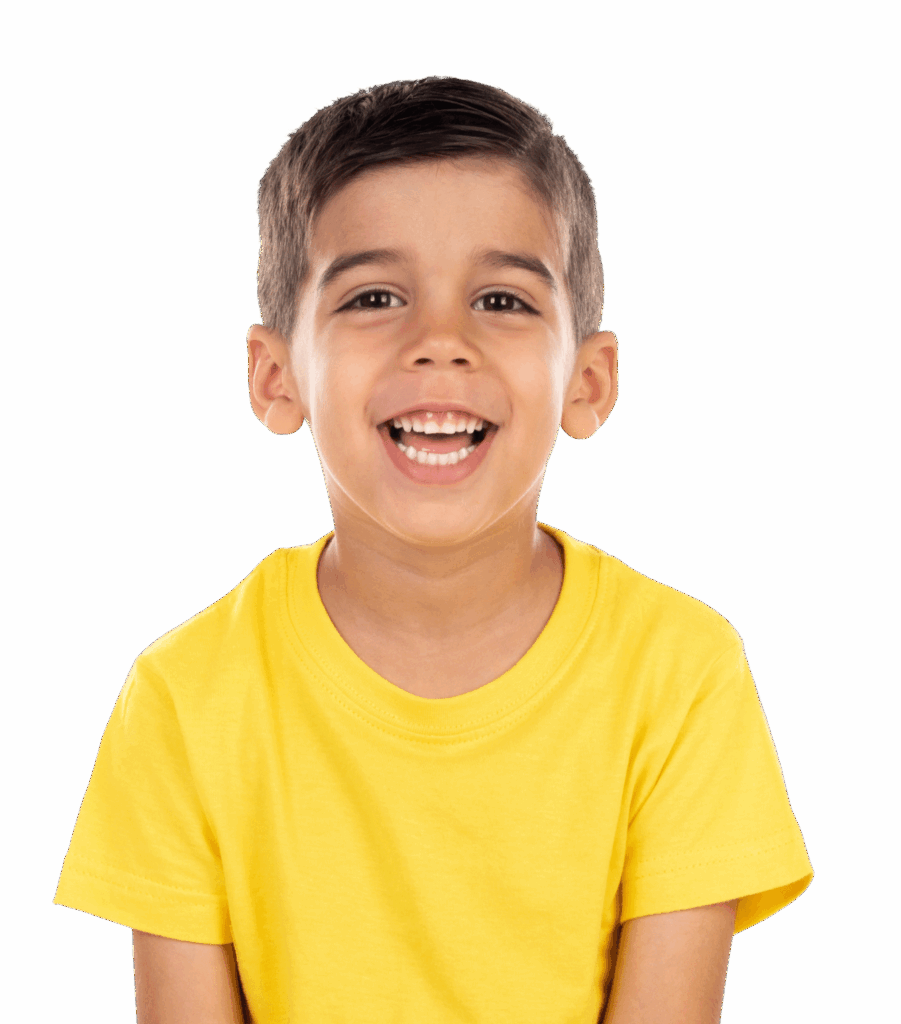 A young boy with short brown hair and a bright smile is wearing a yellow t-shirt. He is facing the camera, seated against a plain black background, creating a vibrant contrast.