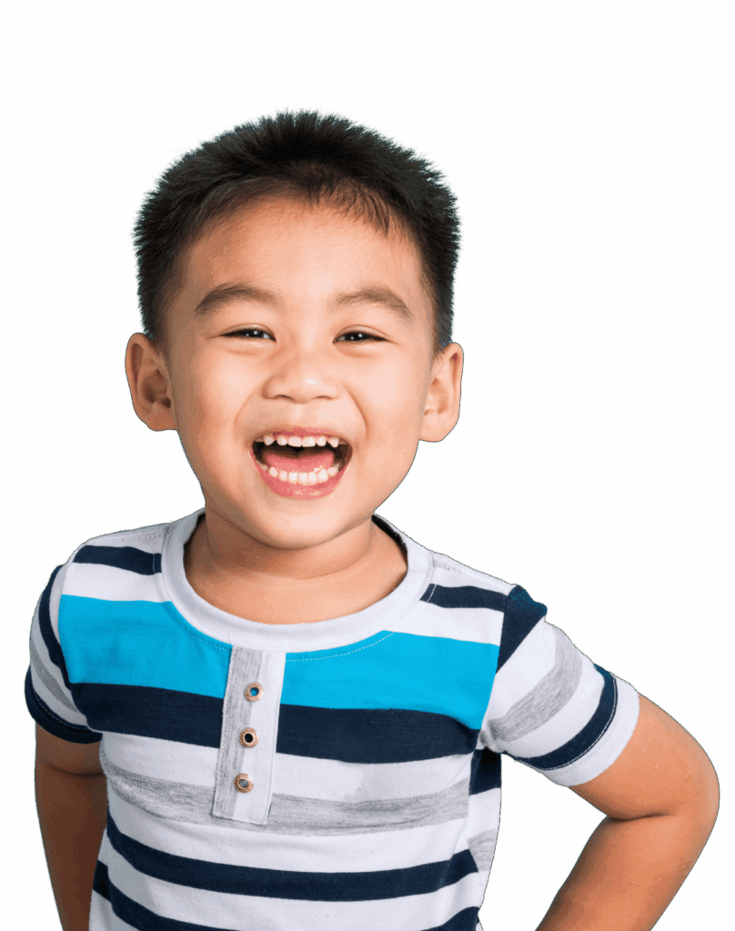 A young boy with short black hair smiles broadly, wearing a striped blue and white shirt with buttons. He stands with one hand on his hip and a cheerful expression against a plain black background.